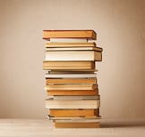 A stack of old books with vintage background